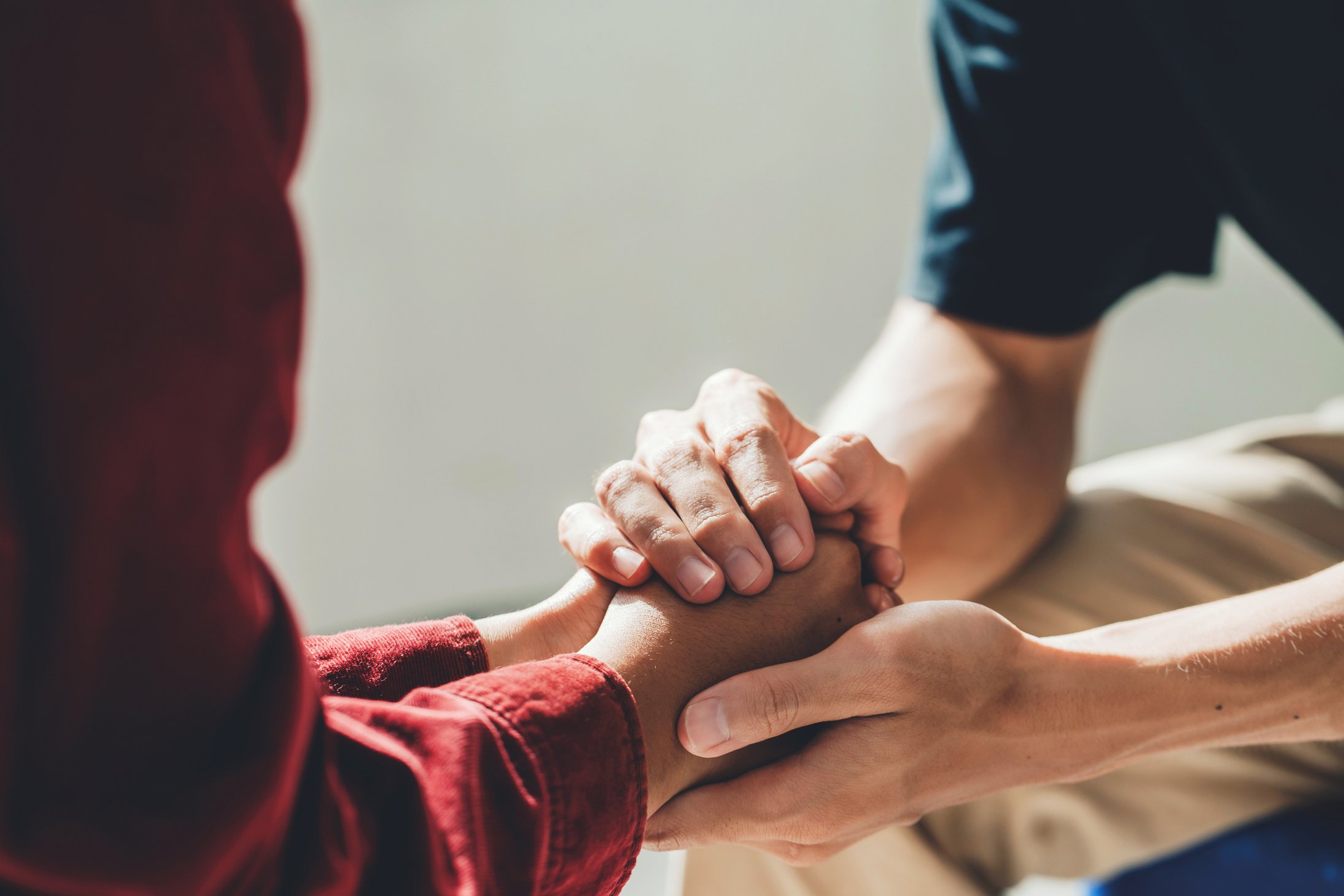 Man Holding a Woman's Hands for Comfort